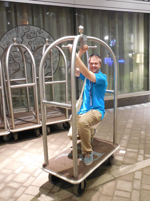 Tom riding a luggage cart at the ACS meeting in Boston