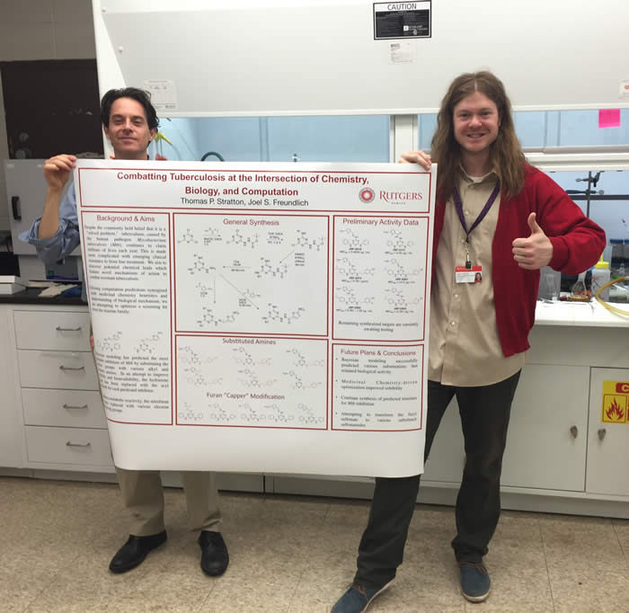 Tom Stratton and Prof. Joel Freundlich displaying Tom's poster for the Newark Research Day