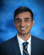 A person in a suit and tie  Description automatically generated
