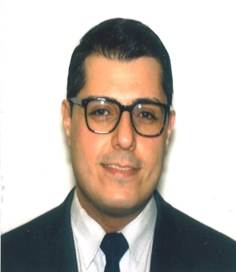 A person wearing glasses posing for the camera Description automatically generated