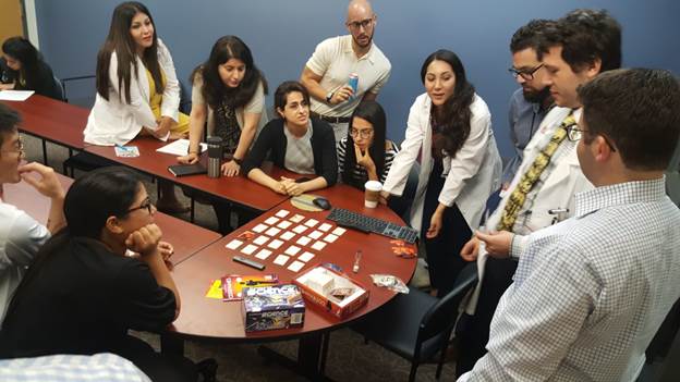 A group of people sitting at a table Description automatically generated