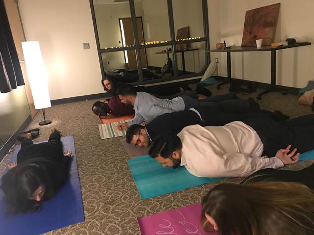 A group of people lying on a bed Description automatically generated